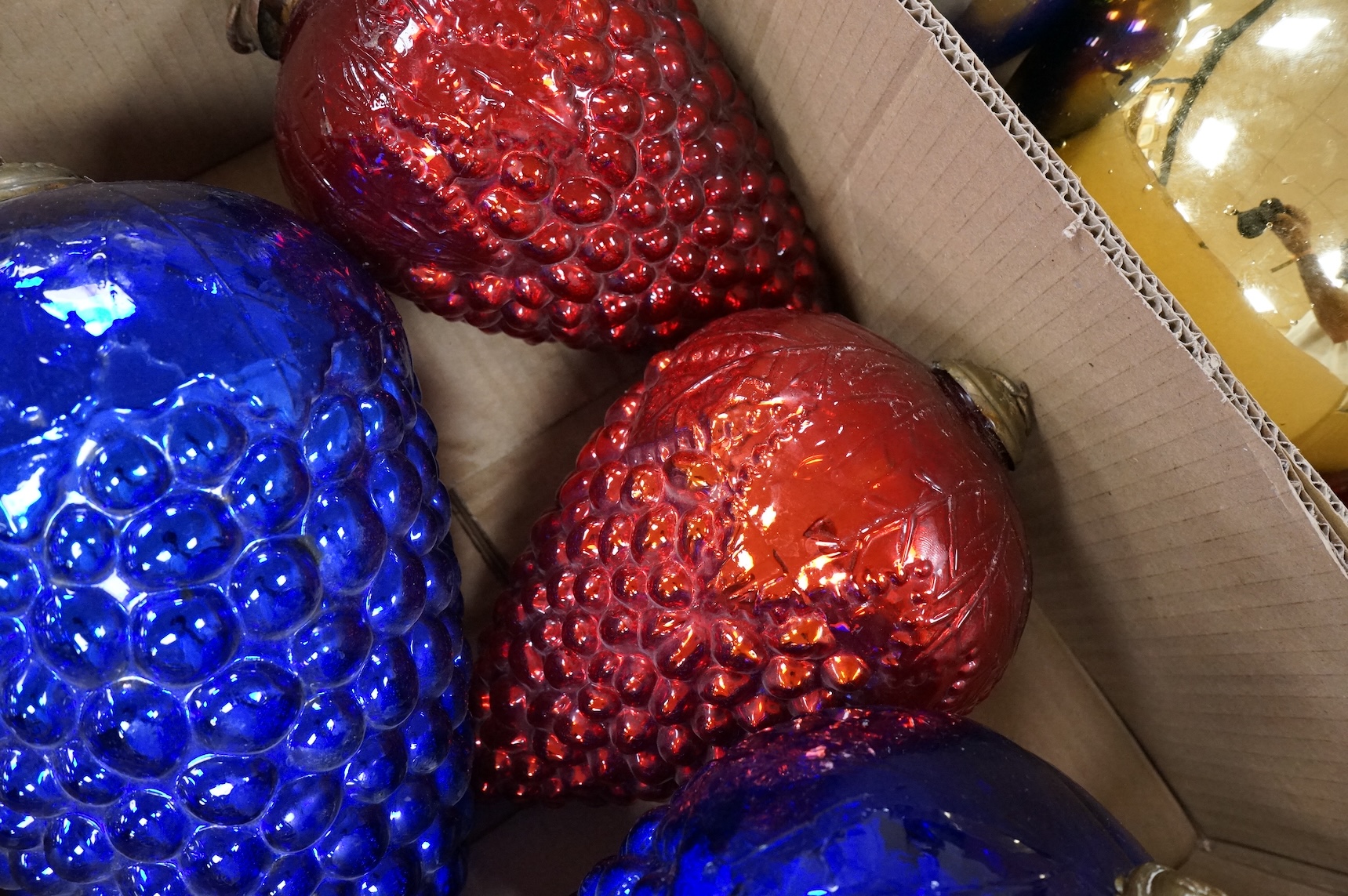 A collection of coloured circular and grape shaped glass witches balls and decorations, largest grape decoration 40cm in length
